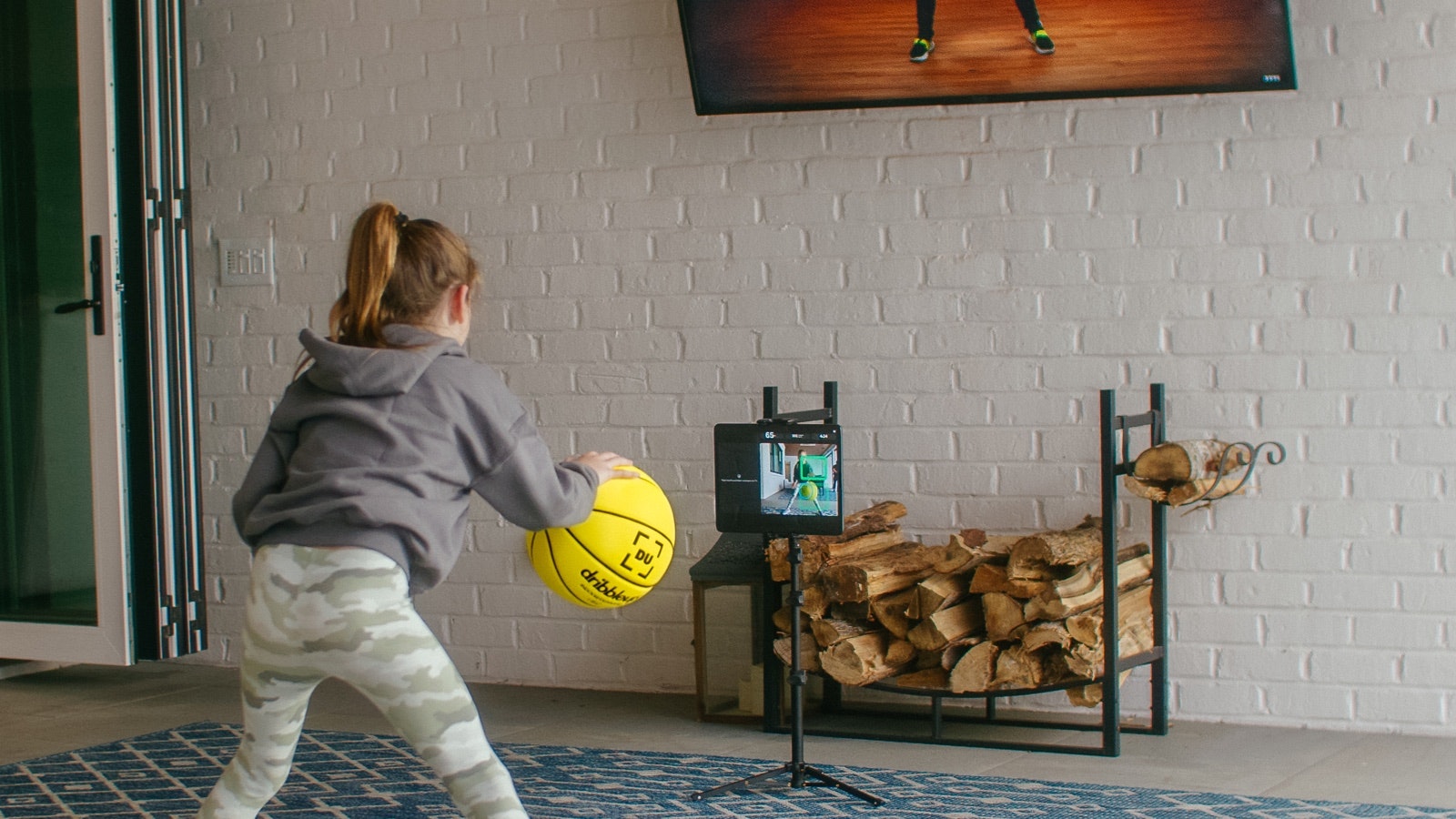 Young girl learning to do a pound dribble with the Dribbleup Smart Basketball.