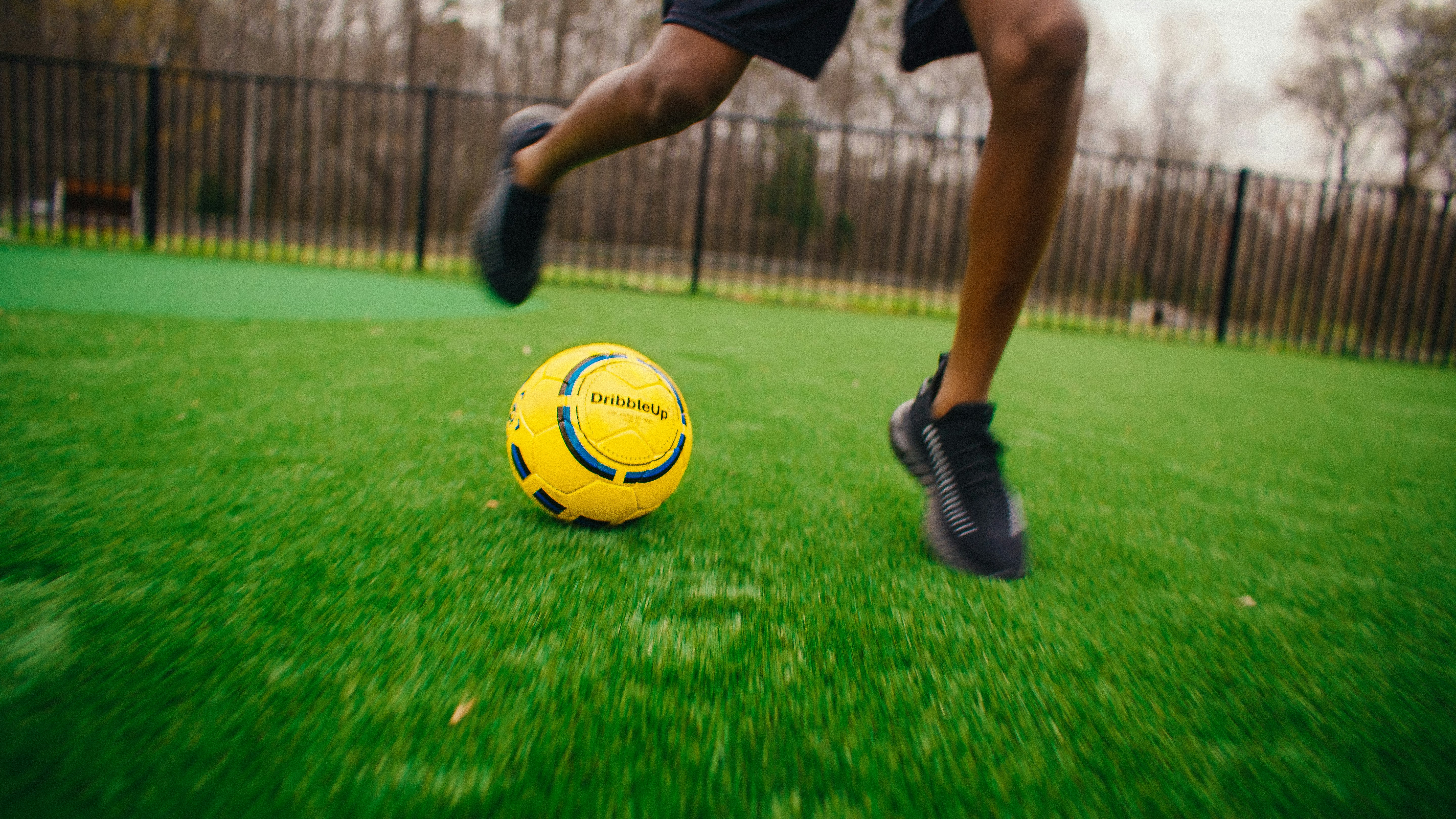 Young kid getting better at soccer by practicing with the Smart Soccer Ball