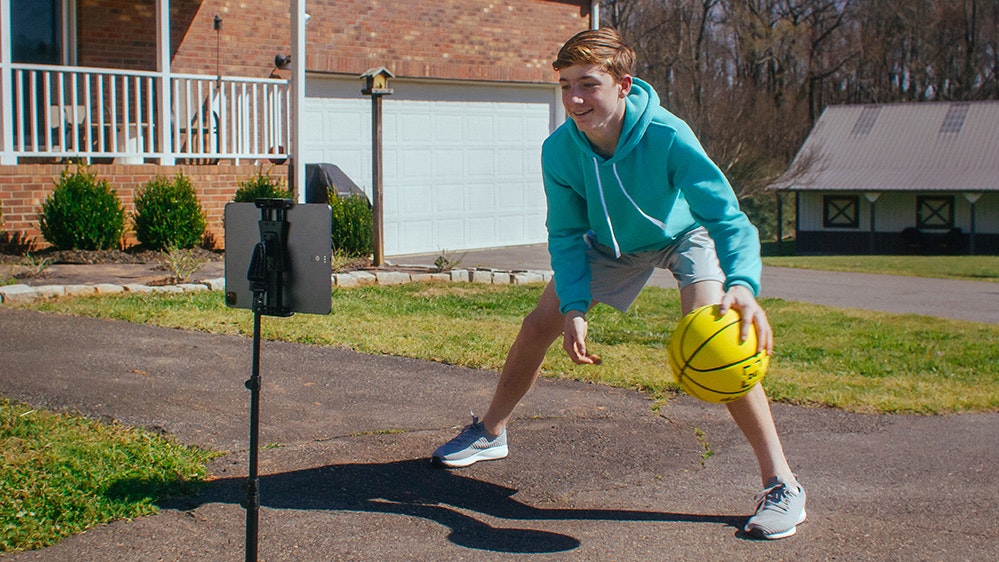 Young boy practices in his driveway at home.