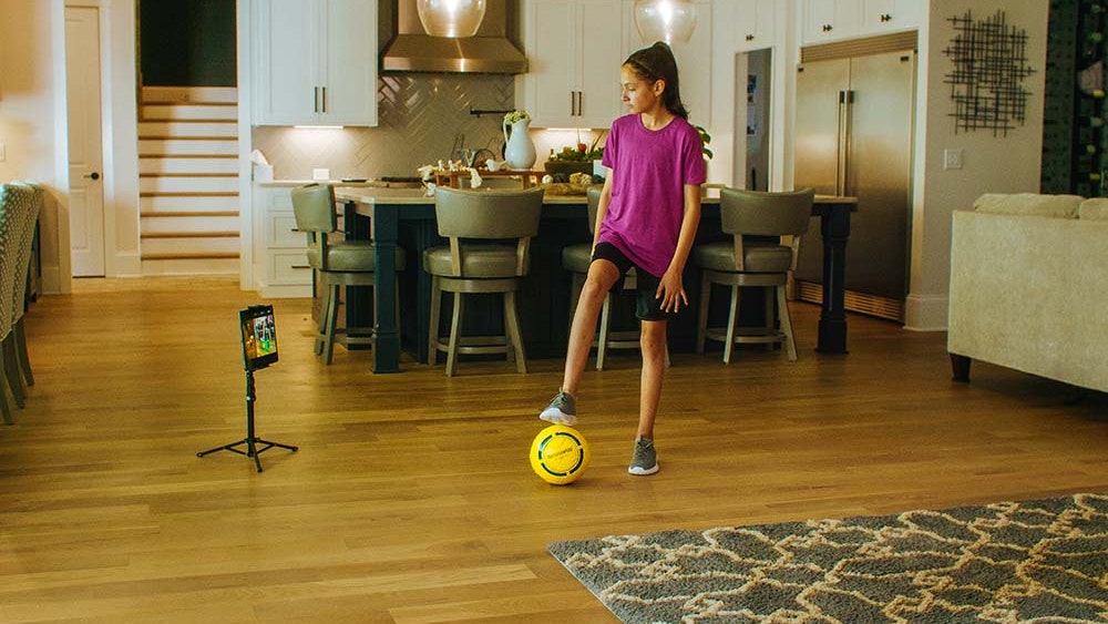 Young girl scanning her Smart Soccer Ball in the Dribbleup app.